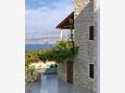 Postira, Brač, Courtyard 3065 - Apartments with pebble beach.